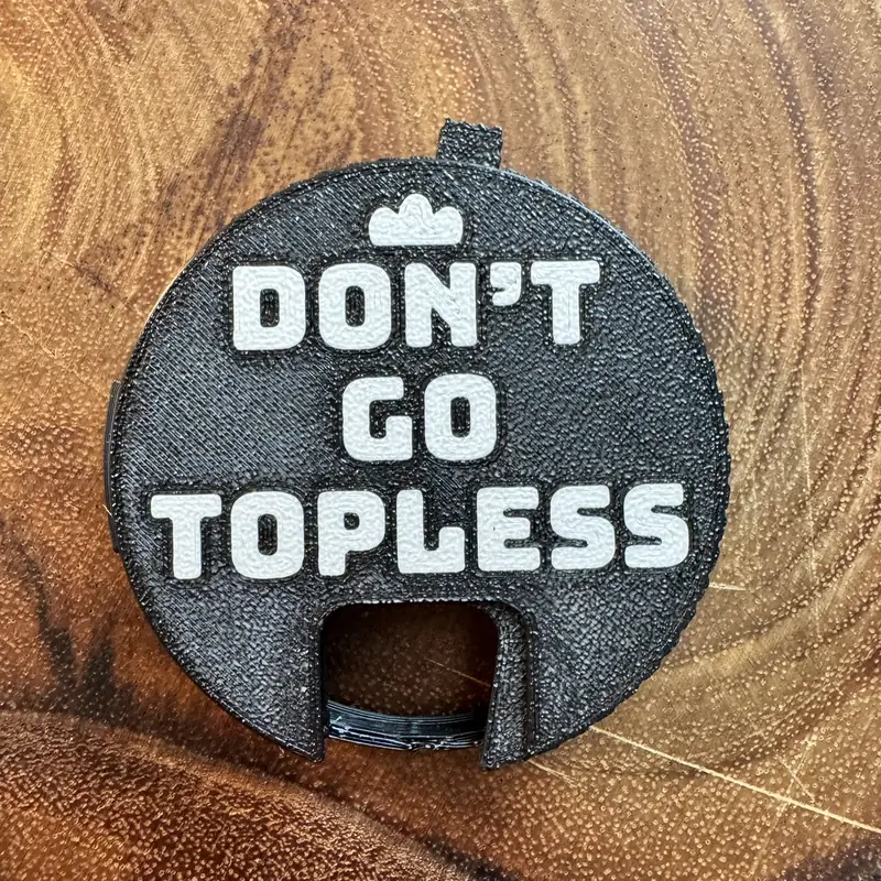 A black Top Block with the line Don't go topless in white, on a wood board