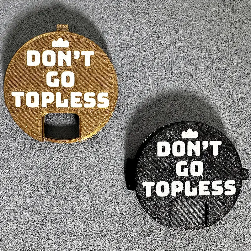 A gold Top Block and a black Top Block, both with the line Don't go topless
