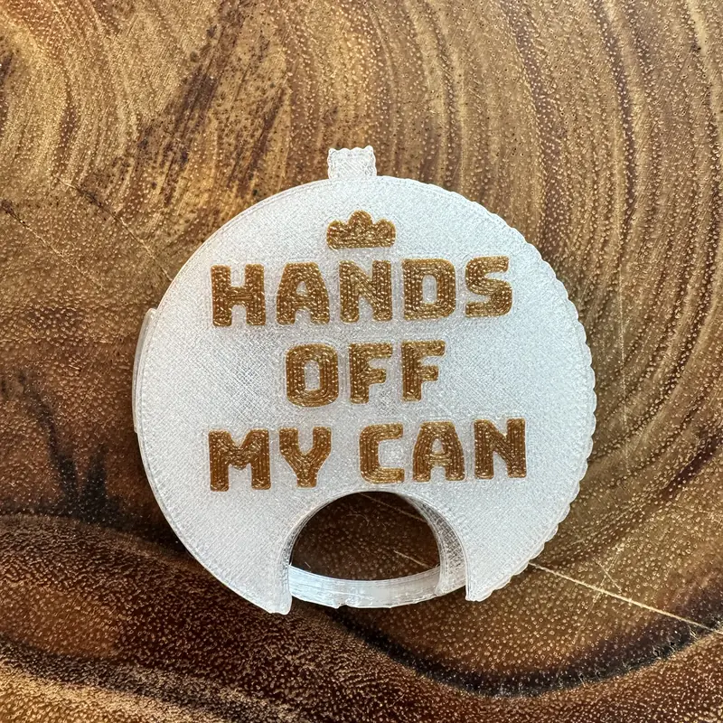 A clear Top Block with the line Hands off my can in gold