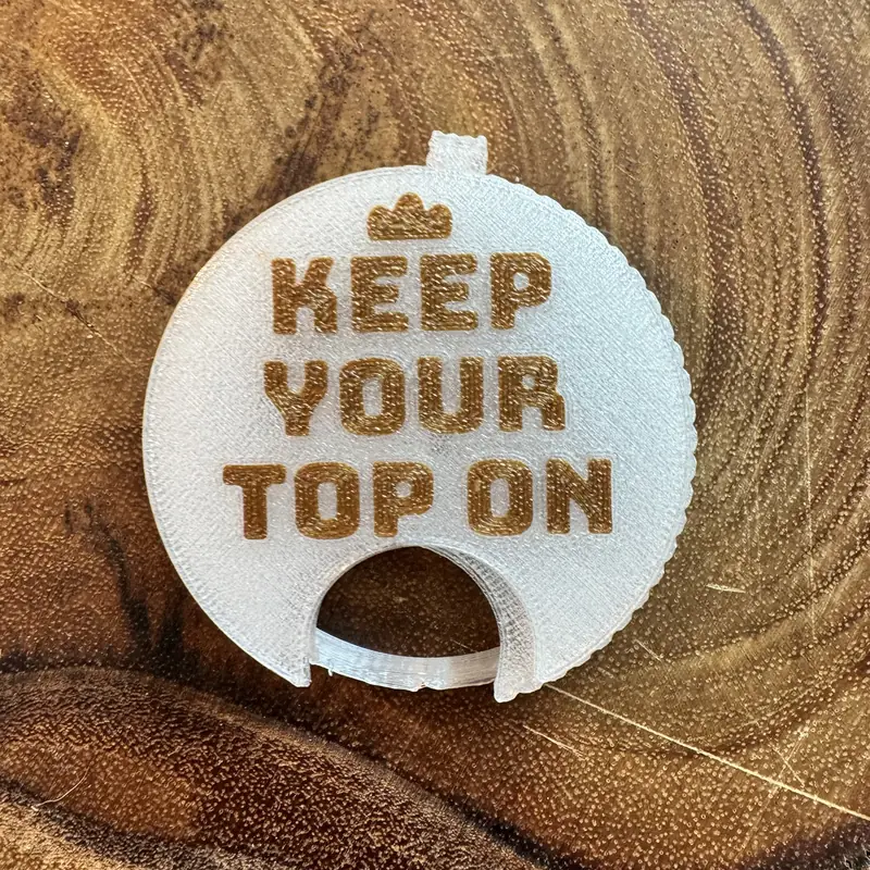 A clear Top Block with the line Keep your top on in gold