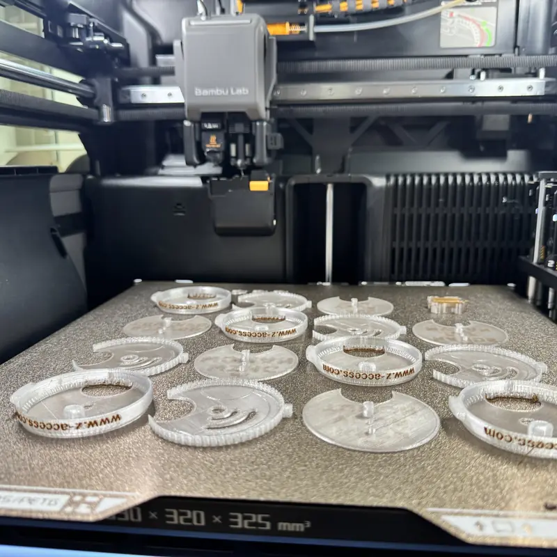 Top Block parts on a 3D printer's build plate, with www.z-access.com printed on the rings