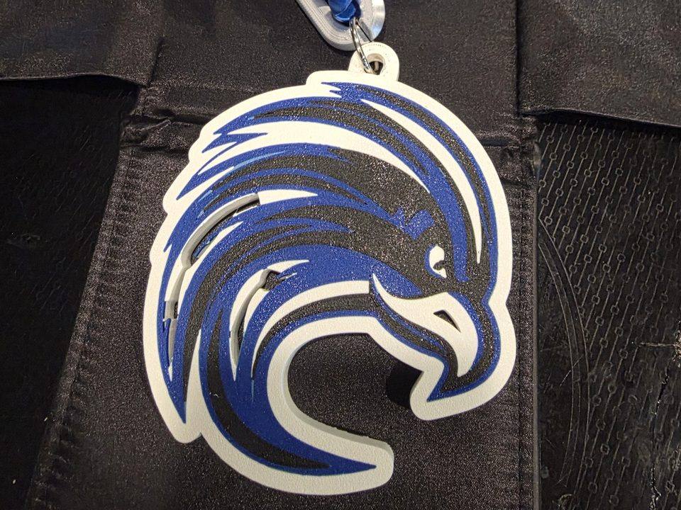 A 3D-printed hype chain we made, with blue and silver links and a large school mascot pendant