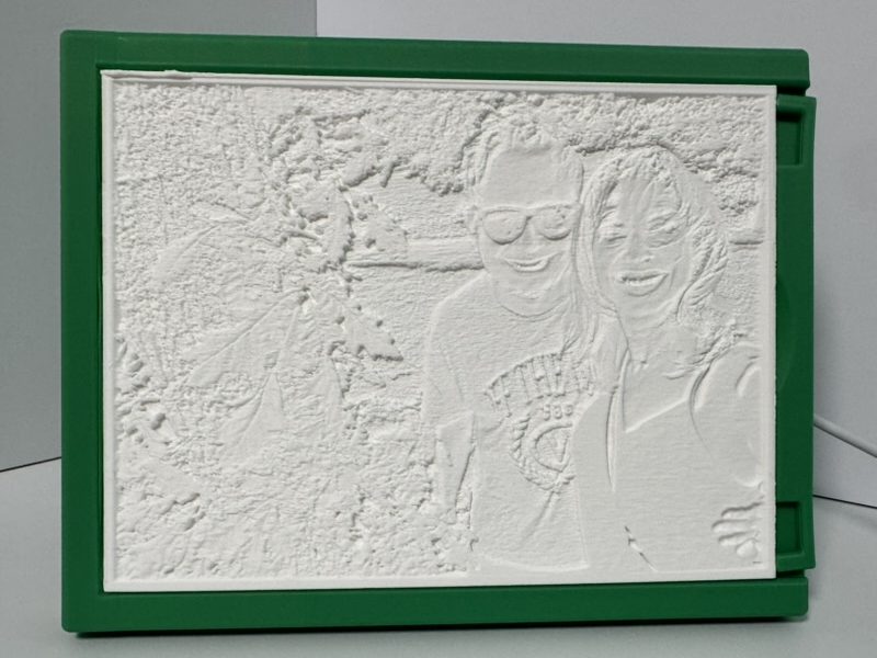 The same lithophane with the light off: a plain white panel with raised texture